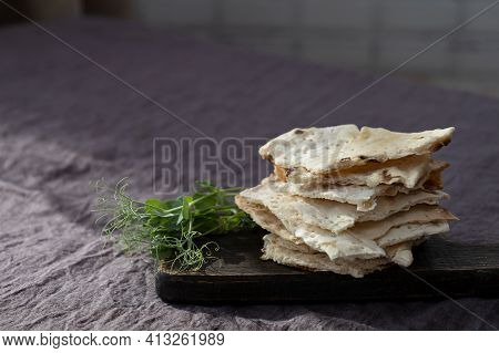 Homemade Matzo  With Microgreen Peas. Unleavened Flatbread Bread. Pesah Celebration Concept.  Jewish