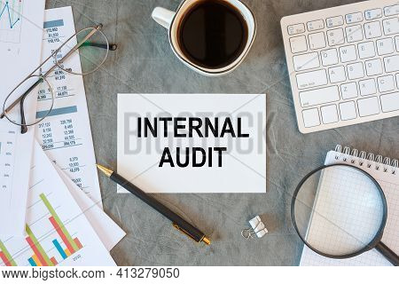 Internal Audit Is Written In A Document On The Office Desk With Office Accessories, Coffee, Keyboard