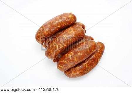 Top View Of Rings Of Raw, Smoked, Medium Minced Sausage In Natural Casings, Isolated On A White Back