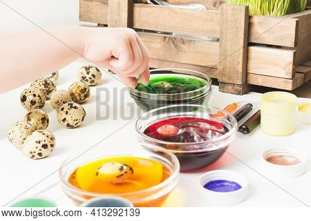 Baby Hand Painted Quial Eggs With Colorful Paints On Table For Easter Holiday