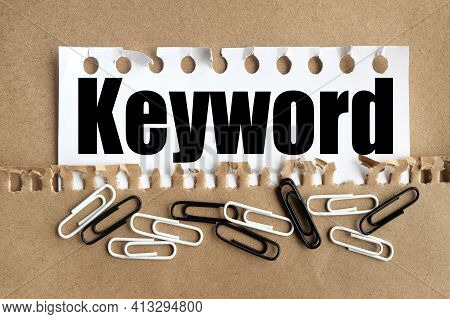 Keywords Concept. Text On White Paper Over Torn Paper Background.
