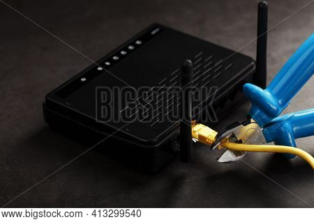 Tearing And Cutting With Blue Wire Cutters The Network Connection Of The Yellow Wire Of The Internet