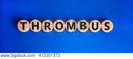 Medical And And Thrombus Symbol. Wooden Circles With The Word 'thrombus'. Beautiful Blue Background.