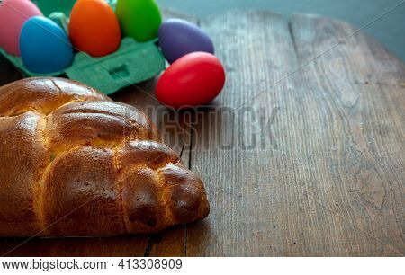 Easter Eggs And Tsoureki Braid, Greek Easter Sweet Bread, On Wooden Background