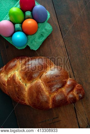 Easter Eggs And Tsoureki Braid, Greek Easter Sweet Bread, On Wooden Background