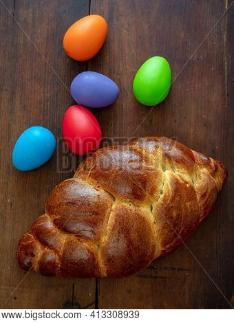 Easter Eggs And Tsoureki Braid, Greek Easter Sweet Bread, On Wooden Background
