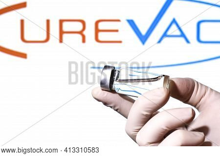 Madrid, Spain- February 23, 2021: Hand Holding Vial With Covid-19 Vaccine And Curevac Logo On White 