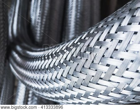 Long Metal Flexible Compensator Pipes Metal Texture Closeup. Selective Focus. White Metal Industrial