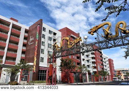 LOS ANGELES, CALIFORNIA - 05 FEB 2020: Jia Apartments and Twin Dragon Gate on Broadway leading into the heart of Chinatown. Chinese characters translate to Welcome. 