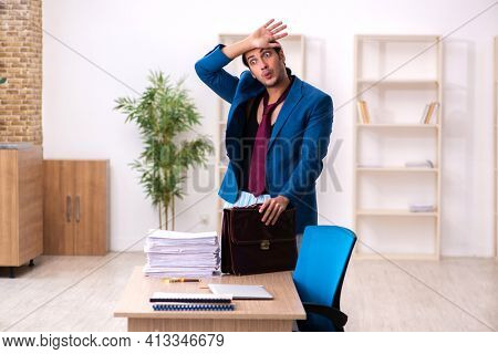 Young male employee in oversleeping concept