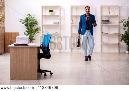 Young male employee in oversleeping concept