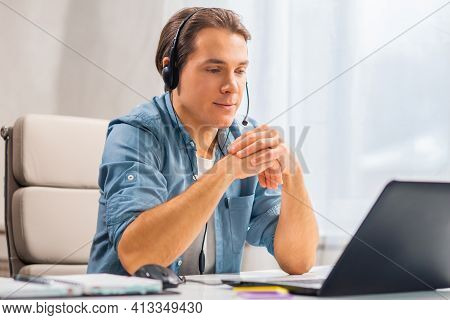 Workplace Of Freelance Worker Or Sudent At Home Office. Young Man Works Using Computer And Other Dev
