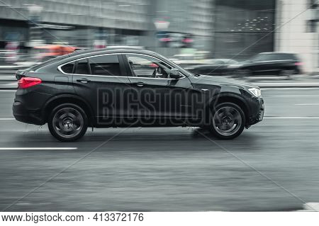 Moscow, Russia - January 2021: Bmw X4 Compact Luxury Crossover Suv Rides Through The City On Wet Sli