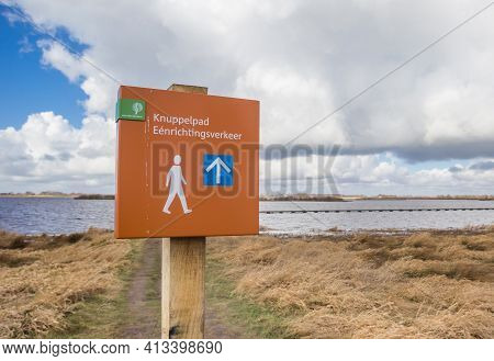 Sign For The One Way Knuppelpad Walking Path Over The Lake In Roegwold, Netherlands