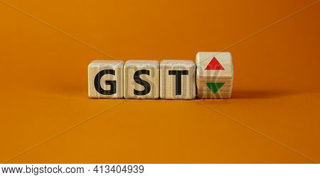 Gst, Goods And Services Tax Symbol. Wooden Cubes With Up And Down Icon. Word 'gst'. Beautiful Orange