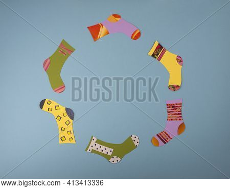World Down Syndrome Day Concept. Different Socks Made From Paper On Blue Background. Flat Lay, Top V