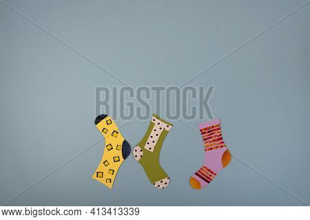 World Down Syndrome Day Concept. Different Socks Made From Paper On Blue Background. Flat Lay, Top V
