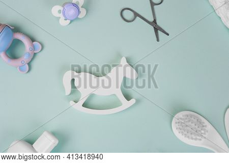 Baby Accessories On Tiffani Background, Flat Lay. Composition With Baby Accessories And Space For Te