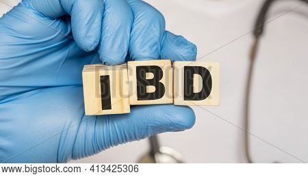 Ibd Inflammatory Bowel Disease - Word From Wooden Blocks With Letters Holding By A Doctor's Hands In