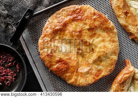 Traditional Homemade Romanian And Moldovan Round Pies - Placinta, Served On A Plate, Dark Background