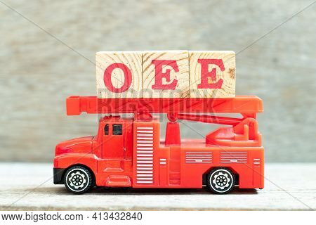 Fire Ladder Truck Hold Letter Block In Word Oee (abbreviation Of Overall Equipment Effectiveness) On