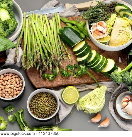 Set Of Various Green Raw Healthy Vegetables On Wooden Board