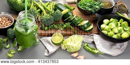 Set Of Various Green Raw Healthy Vegetables On Wooden Board