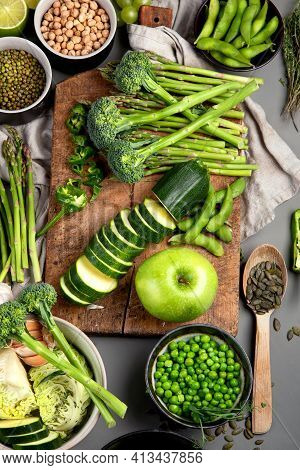 Set Of Various Green Raw Healthy Vegetables On Wooden Board