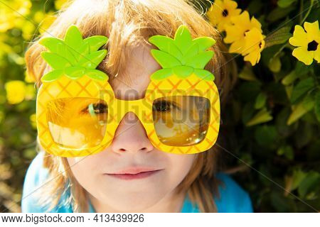 Adorable Child In Summertime With Pineapple Sunglasses. Kid At Sunny Day Outdoor With Sun Glasses