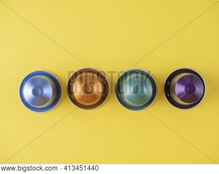 Displayed In A Row Of Colorful Aluminum Capsules With Aromatic Roasted Coffee For The Coffee Machine