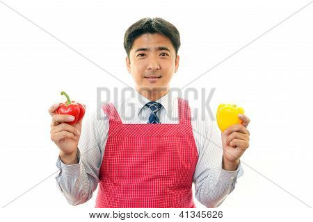 Smiling man holding vegetables