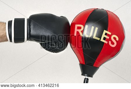Hit The Rules Concept With A Strong Man's Hand In A Boxing Glove Hits The Punching Bag With Text Rul