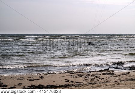 A Young Man Is Engaged In Extreme Kiteboarding In The Gulf Of Riga On October 21, 2020 At Cape Kolka