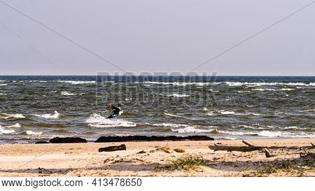 A Young Man Is Engaged In Extreme Kiteboarding In The Gulf Of Riga On October 21, 2020 At Cape Kolka
