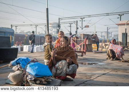 Varanasi. India. 11-02-2018. Mother With Two Children Carrying Some Belongings At The Varanasi Train