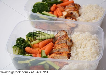 Healthy Balanced Lunch Boxes. Grilled Chicken, Carrots, Cucumbers, Broccoli, And White Rice. Lunch B