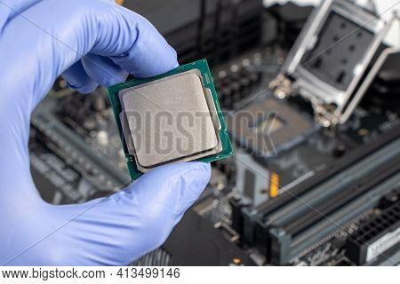 Plug In Cpu Microprocessor To Motherboard Socket. Technological Background. Concept Computers Harwar