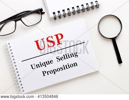 Usp Unique Selling Proposition Is Written In A White Notebook On A Light Background Near The Noteboo