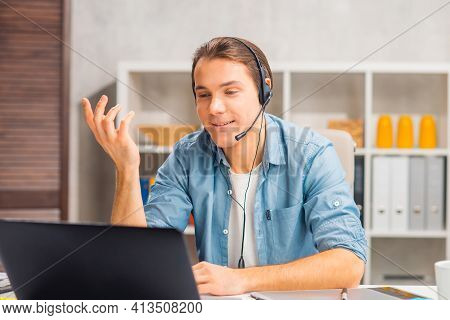 Workplace Of Freelance Worker Or Sudent At Home Office. Young Man Works Using Computer And Other Dev