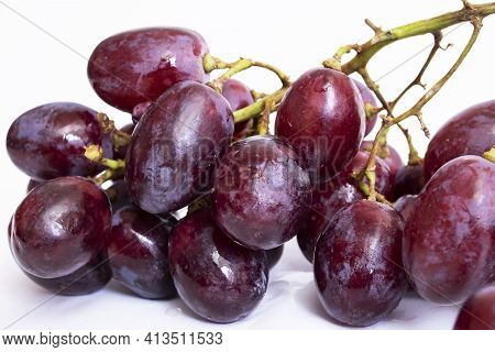 Bunch Of Red Grapes On White Background Close Up