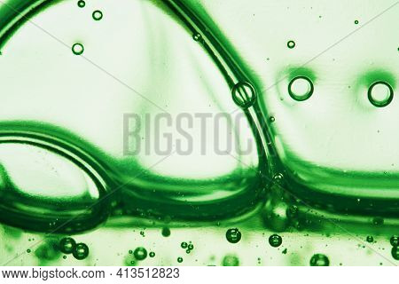 Liquid Cosmetic Smudge Texture. Green Cream Serum Gel Transparent Cosmetic With Oxygen Bubbles. Hyal