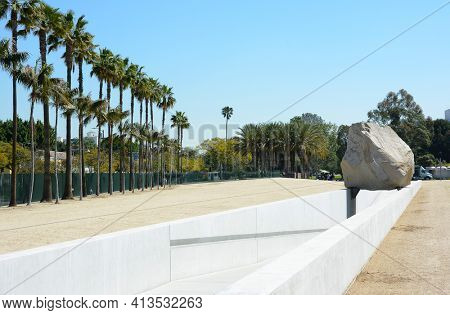 LOS ANGELES - MARCH 28, 2018: Levitated Mass art installation at the Los Angeles County Museum of Art. By Michael Heizer it weighs 340 tons with a trench visitors can walk through.