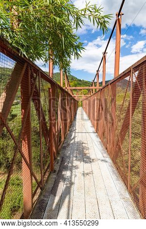 Iron Bridge With Mountains And Forest