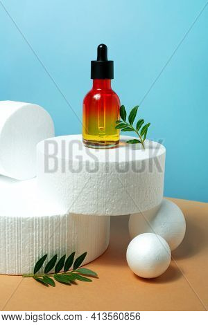 Bottle With Pipette Essential Oil, Serum On Blue And Bige Background. Face, Skin Care Organic Beauty