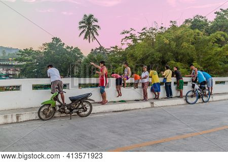 Loboc, Philippines - Feb 10, 2018: Local Men Are Fishing From A Bridge In Loboc Village, Bohol Islan