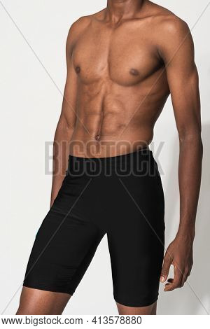 Man in black compression shorts for swimwear fashion shoot