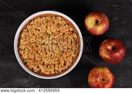 Top View Of Whole Traditional European Apple Pie With Topping Crumbles In White Springform Pan On Da