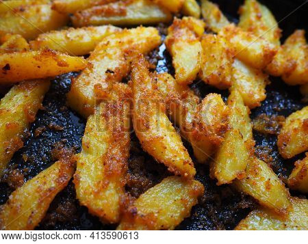 Fried Potatoes Or French Fries With Turmeric, Curry And Bread Crumbs. Close-up. Delicious Side Dish.