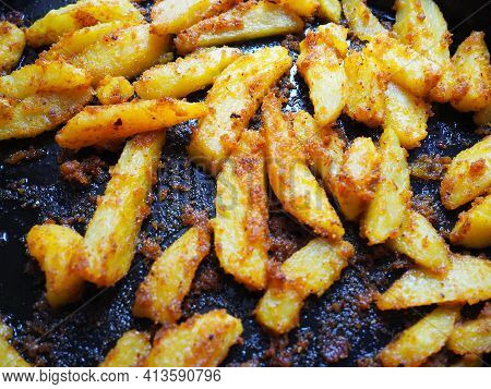 Fried Potatoes Or French Fries With Turmeric, Curry And Bread Crumbs. Close-up. Delicious Side Dish.