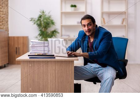 Young male employee in oversleeping concept